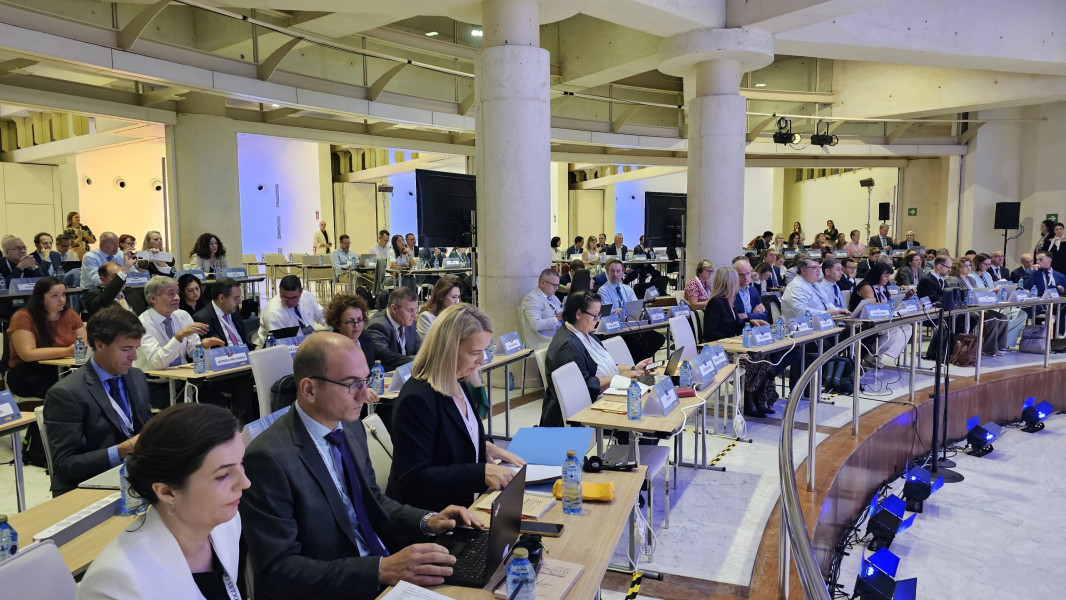 Panorâmica da sala com vários participantes sentados