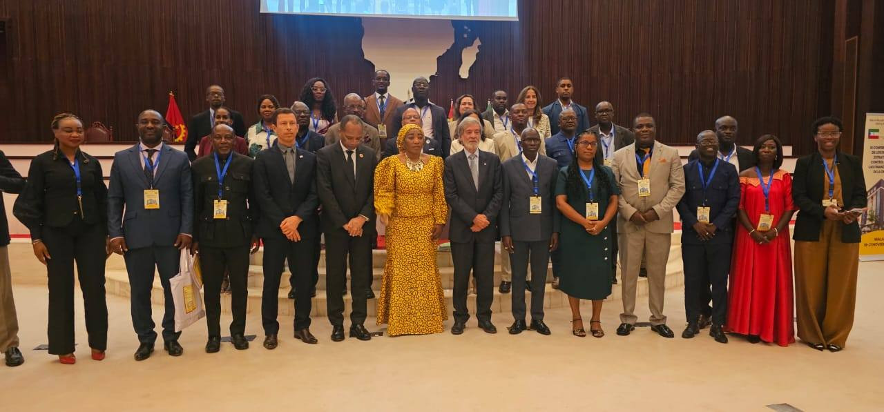 Fotografia de grupo com vários membros das delegações presentes na conferência, em pé em frente a uma escada