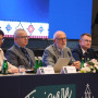 Foto do painel de 4 oradores sentados à mesa da conferência 33rd  Homologues Group Meeting